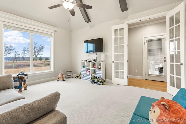 living room with french doors, ceiling fan, and carpet