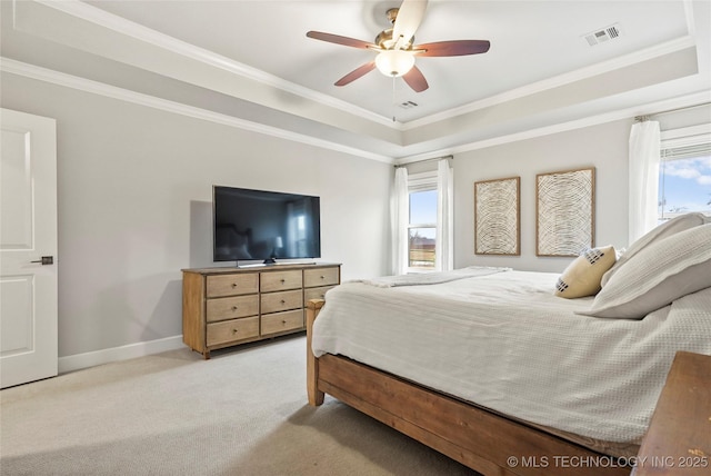 carpeted bedroom featuring crown molding, ceiling fan, and a tray ceiling