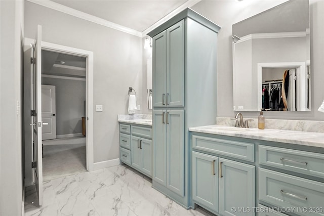 bathroom with ornamental molding and vanity