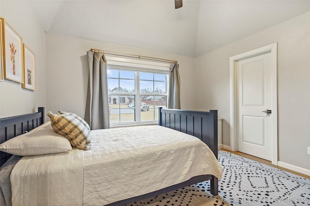 bedroom featuring lofted ceiling, wood-type flooring, and ceiling fan