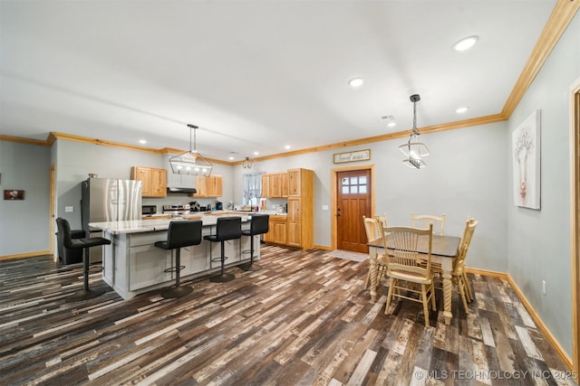 dining space with crown molding and dark hardwood / wood-style flooring