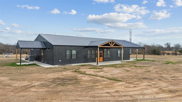 back of house with central AC unit