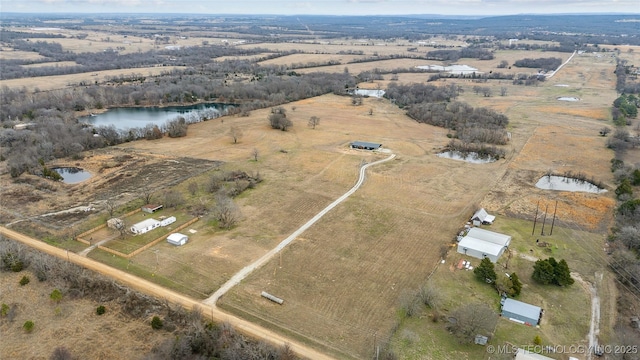 birds eye view of property with a water view and a rural view