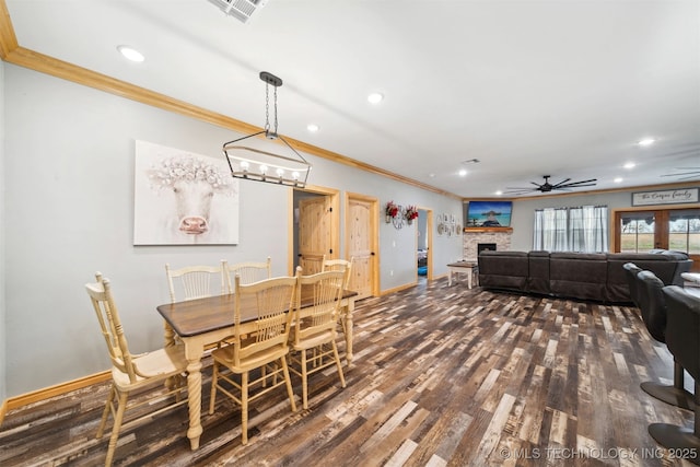 dining area featuring ceiling fan, ornamental molding, and dark hardwood / wood-style flooring