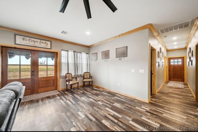 sitting room featuring crown molding, dark hardwood / wood-style flooring, and a wealth of natural light