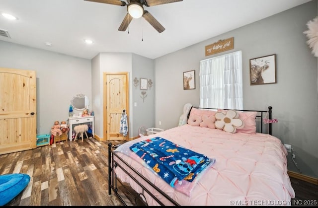 bedroom with dark hardwood / wood-style flooring and ceiling fan