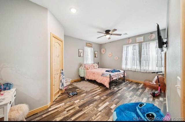 bedroom featuring dark wood-type flooring and ceiling fan