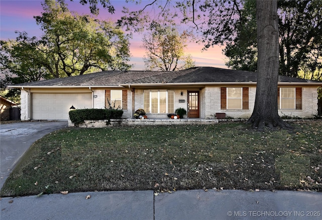 single story home with a garage and a yard