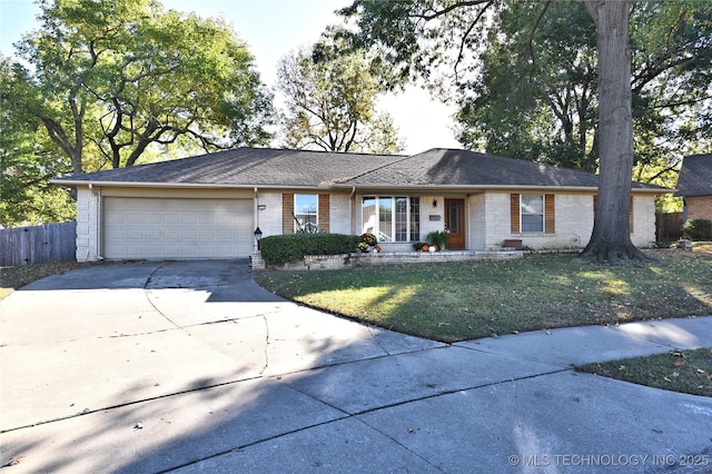 single story home with a garage and a front lawn