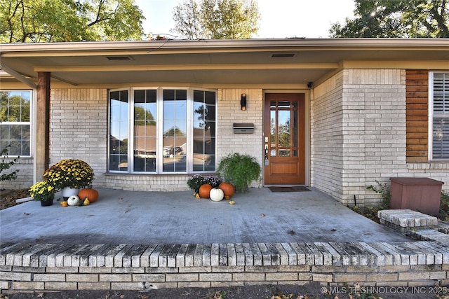 property entrance with a wooden deck