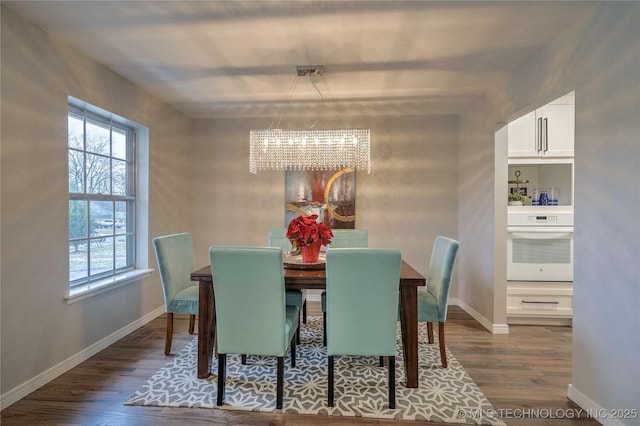 dining area featuring dark hardwood / wood-style floors, a wealth of natural light, and a chandelier