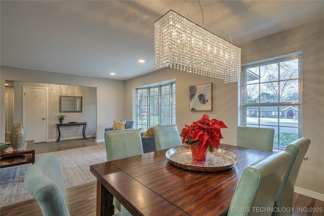 dining space with a wealth of natural light and wood-type flooring