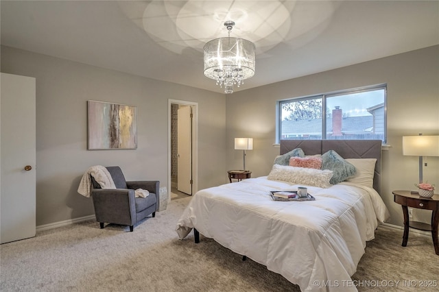 carpeted bedroom with a chandelier