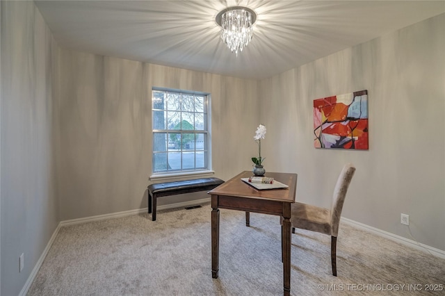 carpeted office featuring a notable chandelier