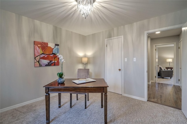 carpeted office space with a notable chandelier