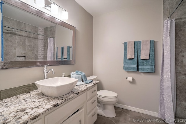 bathroom with tile patterned flooring, vanity, toilet, and walk in shower