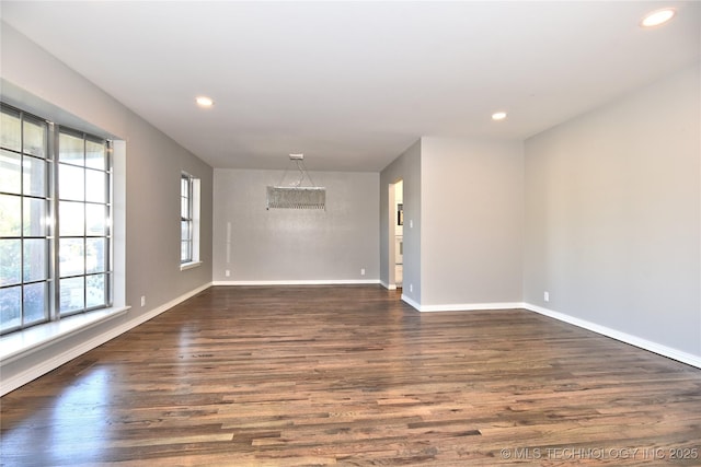 spare room with dark hardwood / wood-style flooring