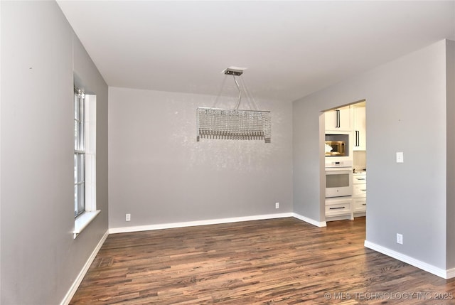 empty room featuring dark wood-type flooring