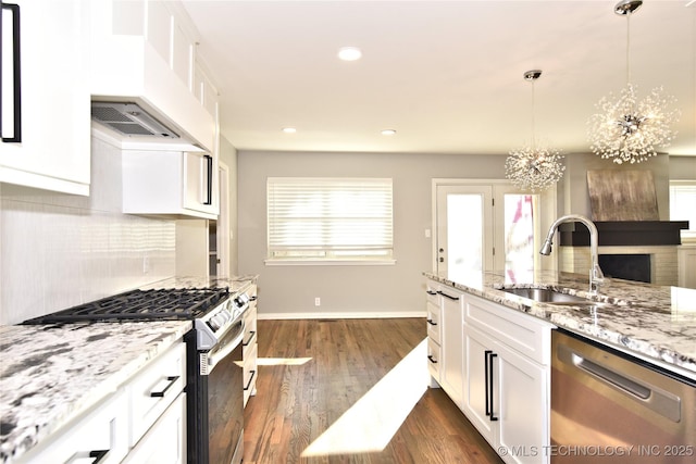 kitchen featuring stainless steel appliances, white cabinetry, and sink