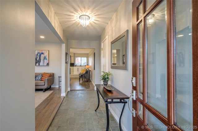 hallway featuring a chandelier