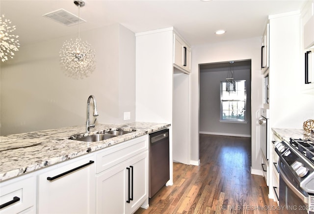 kitchen featuring sink, light stone counters, decorative light fixtures, stainless steel appliances, and white cabinets