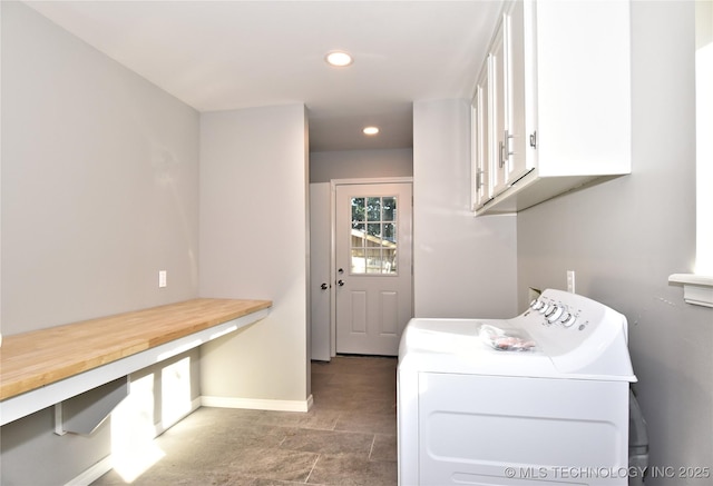 clothes washing area featuring cabinets and independent washer and dryer