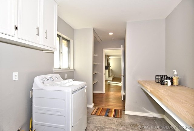 clothes washing area featuring cabinets