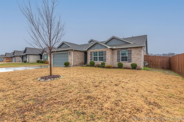 ranch-style home featuring a garage and a front yard