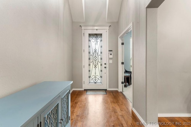 entrance foyer featuring baseboards and wood finished floors