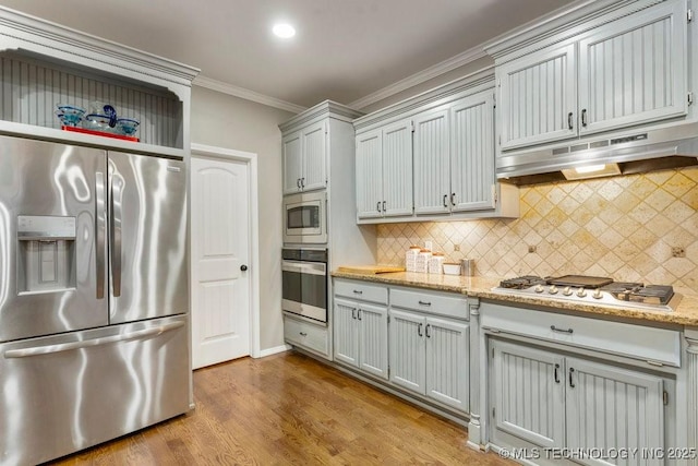 kitchen featuring under cabinet range hood, stainless steel appliances, open shelves, light wood finished floors, and crown molding