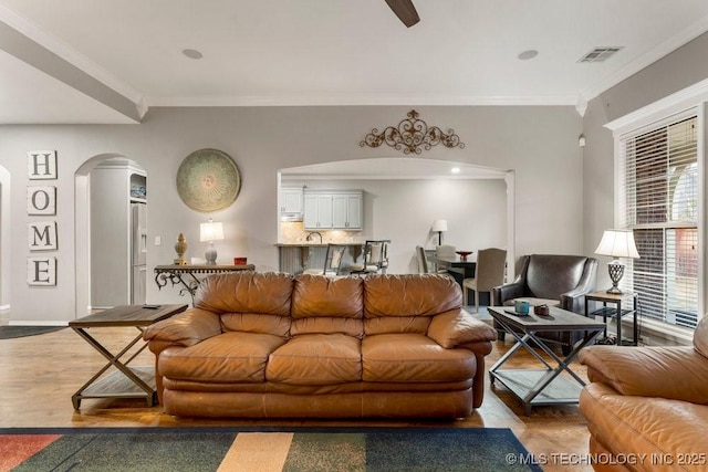 living room with hardwood / wood-style flooring and ornamental molding