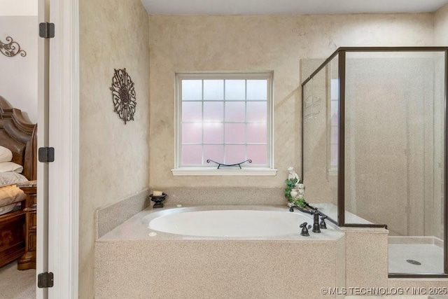 bathroom with shower with separate bathtub