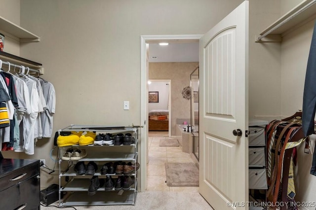 walk in closet with light tile patterned flooring