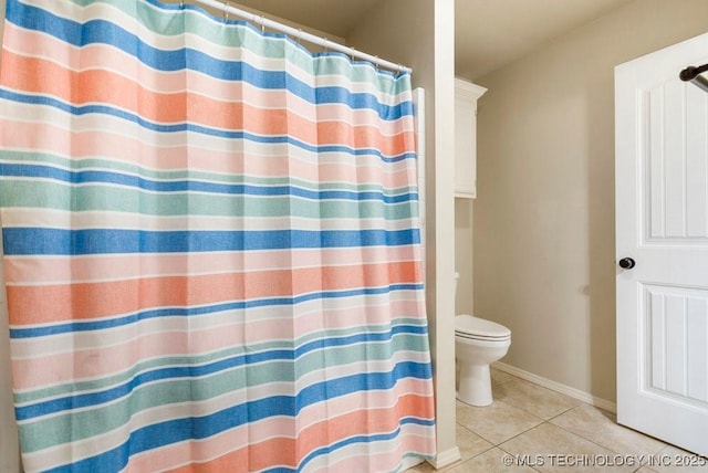 bathroom featuring tile patterned flooring and toilet