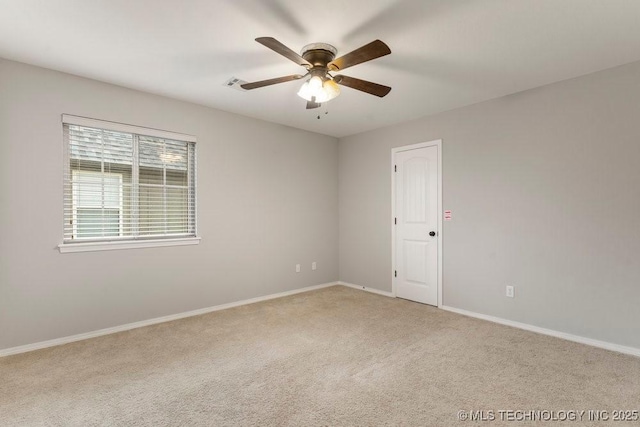 carpeted spare room with ceiling fan