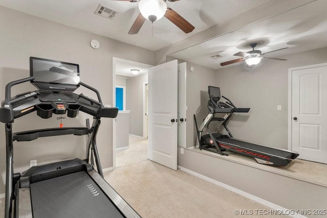 workout area featuring baseboards, visible vents, a ceiling fan, and light colored carpet