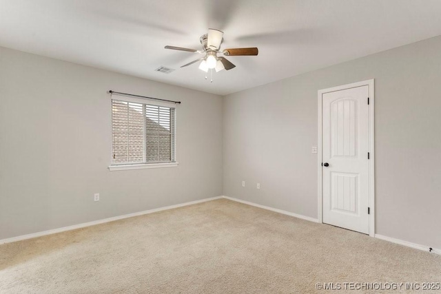 carpeted empty room featuring ceiling fan