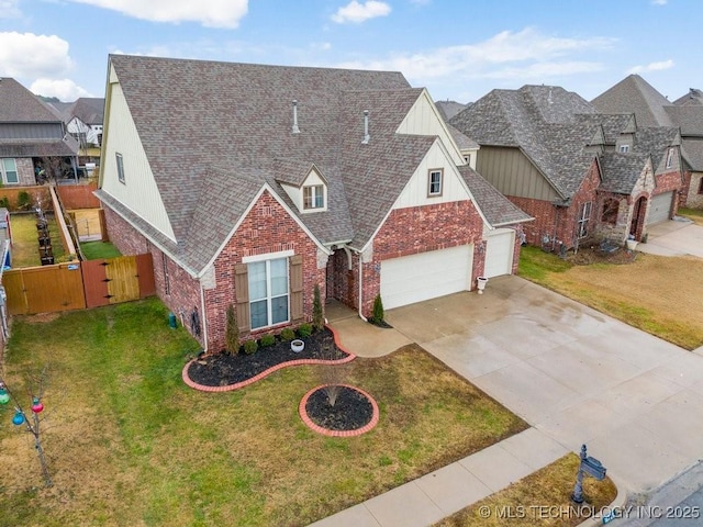 view of front facade featuring brick siding, roof with shingles, an attached garage, a front yard, and fence