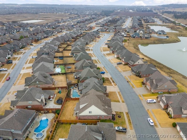 aerial view with a water view and a residential view