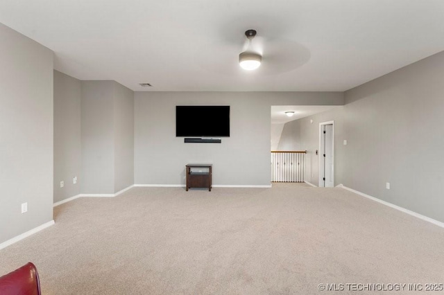 unfurnished living room featuring visible vents, baseboards, and light colored carpet