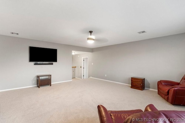 living room with visible vents, baseboards, and light colored carpet