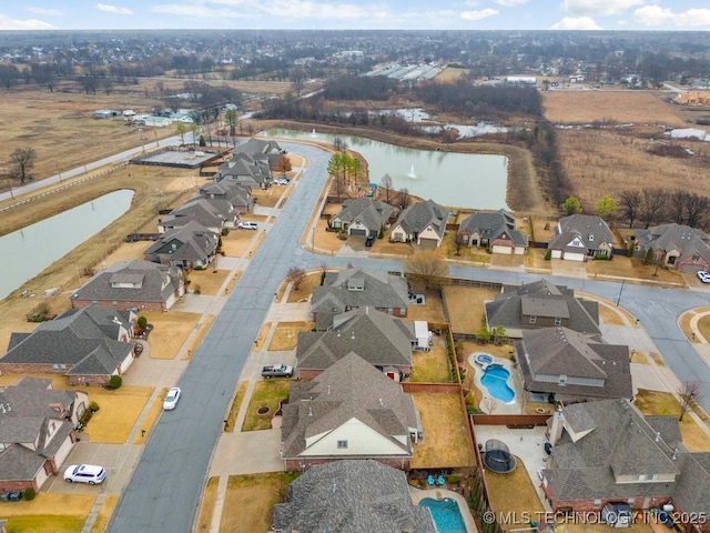 bird's eye view with a residential view and a water view