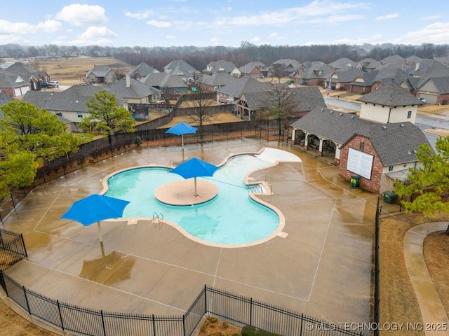 pool featuring a residential view, a fenced backyard, and a patio area