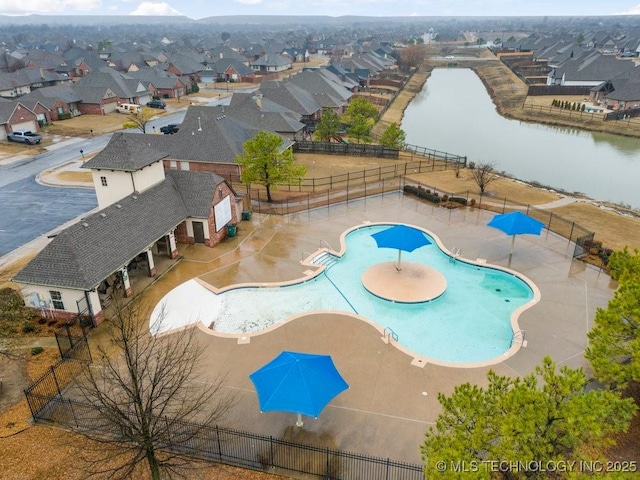 view of pool with a water view and a patio area