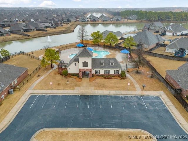 birds eye view of property with a residential view and a water view