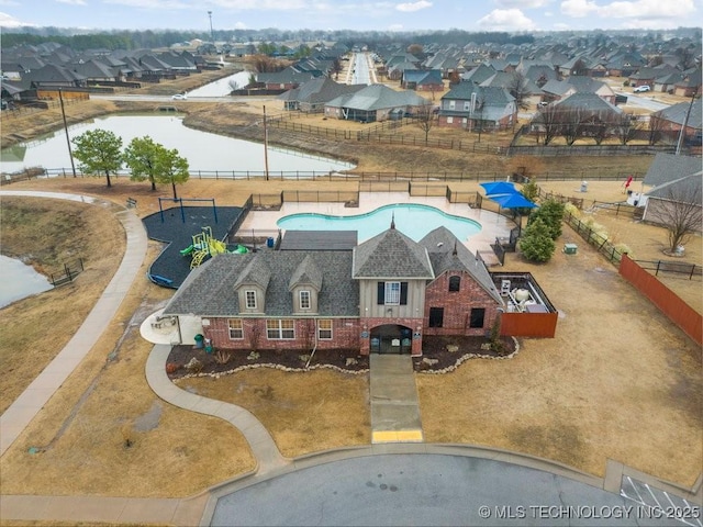 drone / aerial view with a water view and a residential view