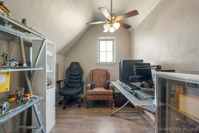 office space with lofted ceiling, a textured ceiling, wood finished floors, and a ceiling fan