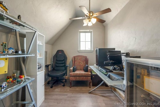 office space with wood finished floors, ceiling fan, and lofted ceiling