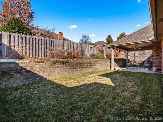 view of yard with a patio area and ceiling fan