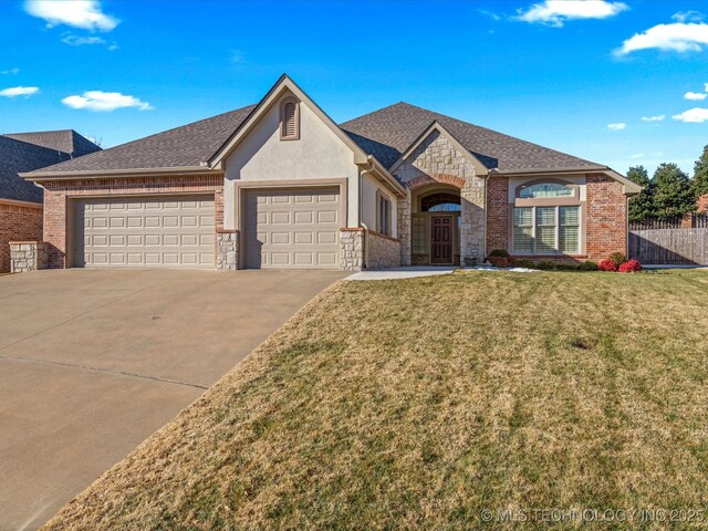 view of front of house featuring a garage and a front yard